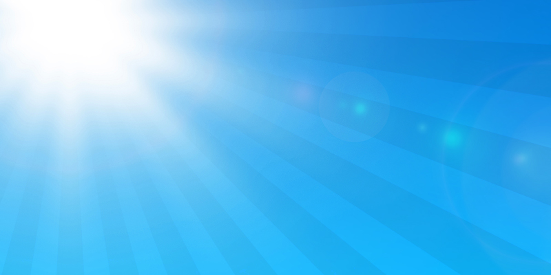 A sun shining on a blue sky