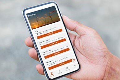 Hand holding mobile phone with SaskPower App on