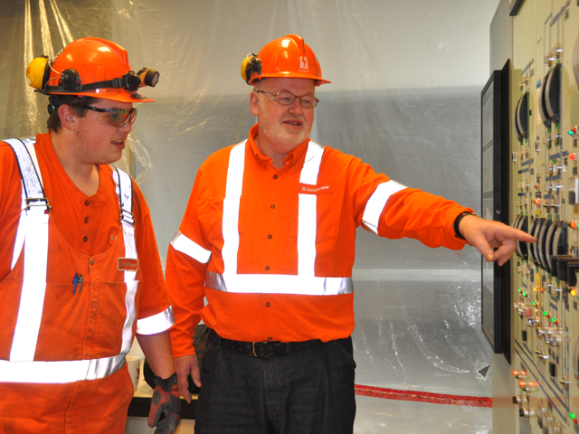 Two employees inside plant