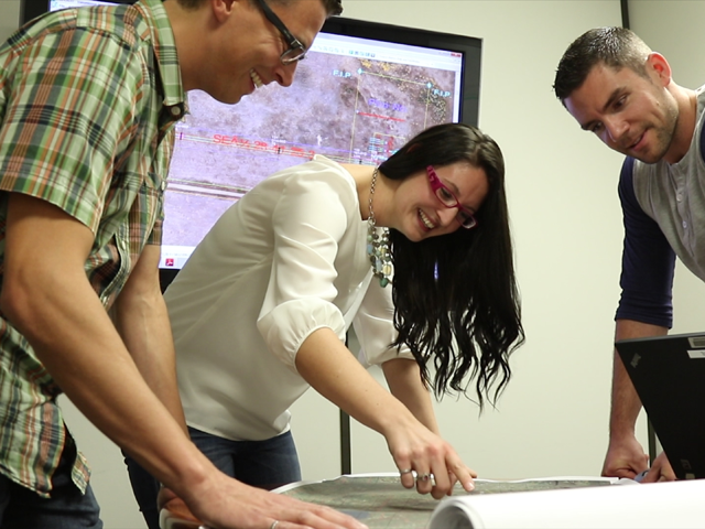 Employees inside looking at map